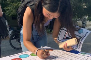 student signing ecopledge