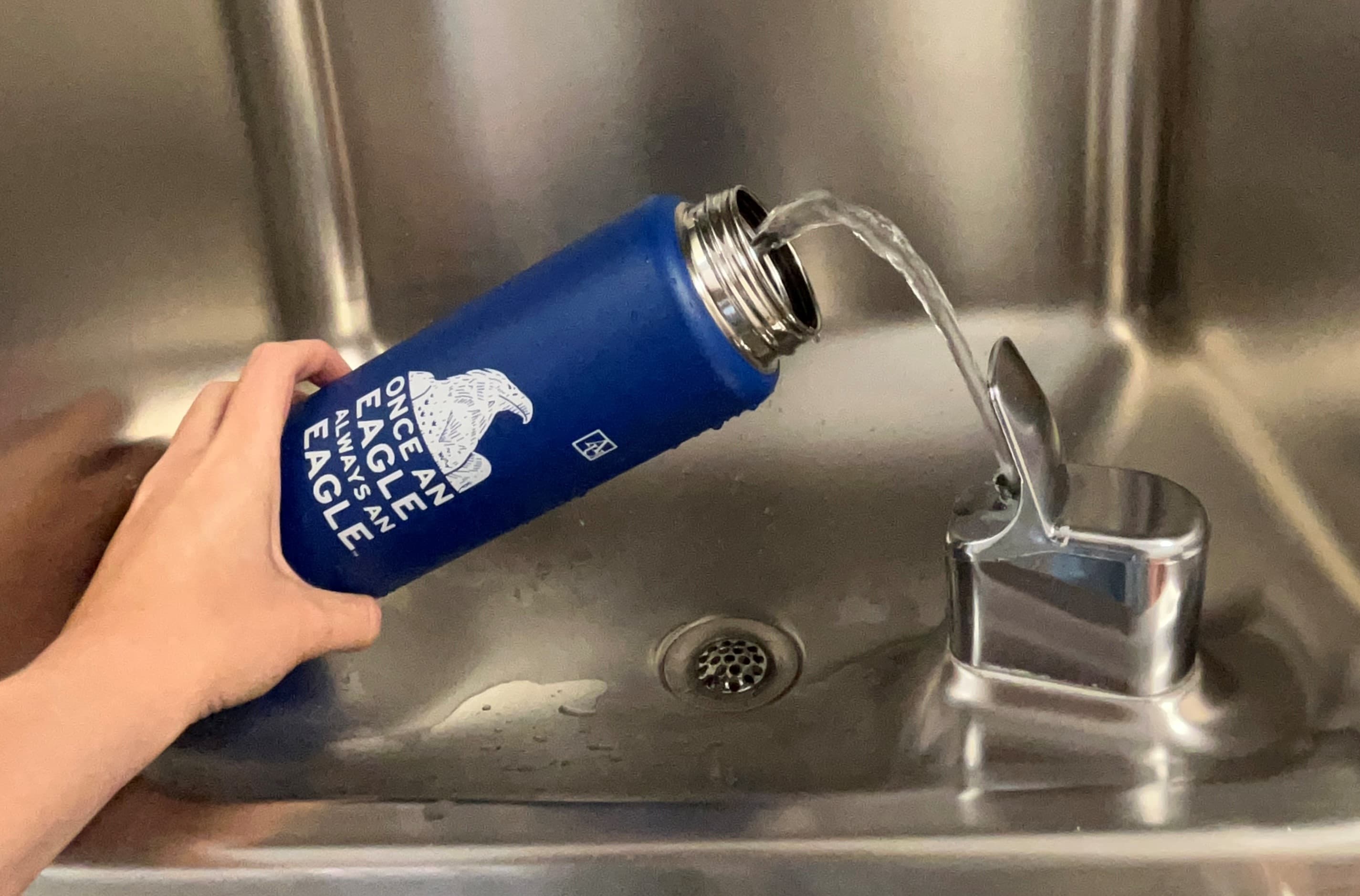 hand holding AU branded water bottle