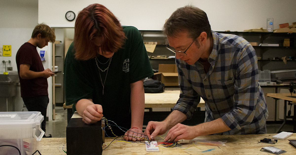 Andy Holtin and student working in the lab