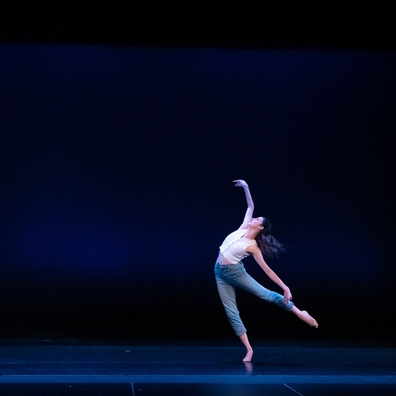 Dancer balances on one foot, limbs outstretched