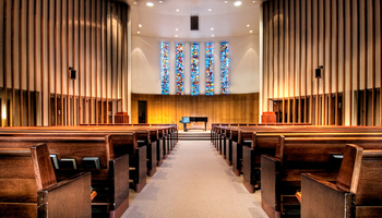 Inside the Kay Spiritual Life Center with pews and stained glass windows