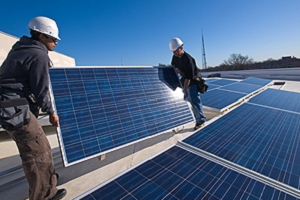 People installing a solar panel