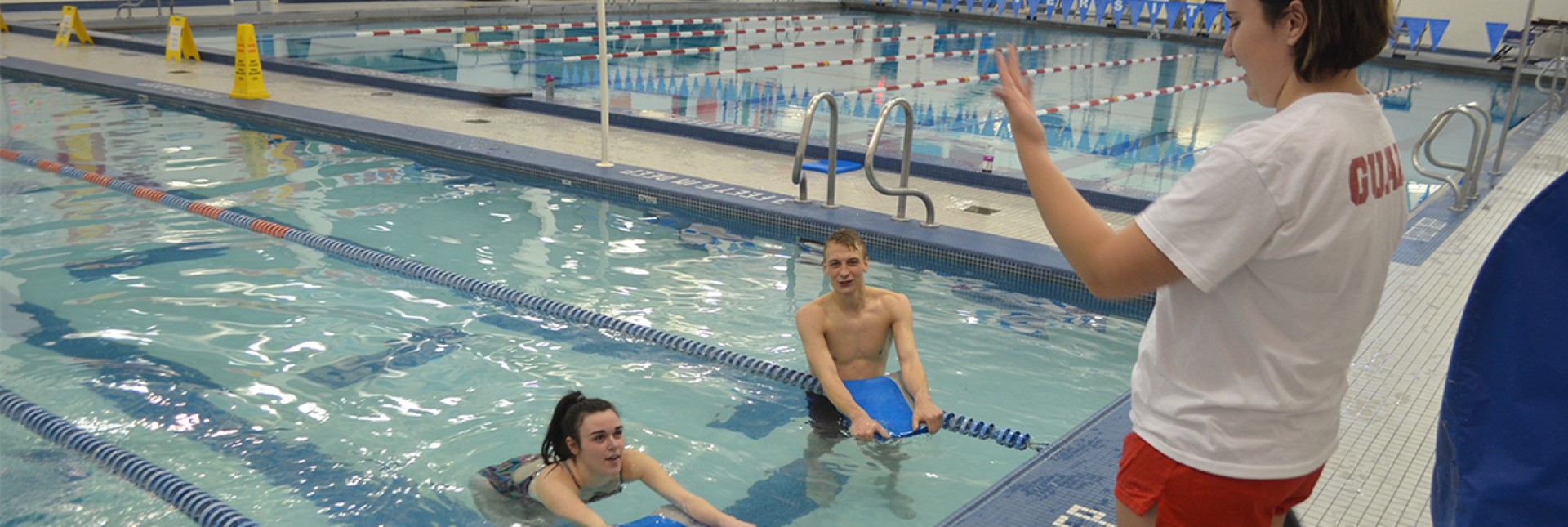 guard talking with swimmers