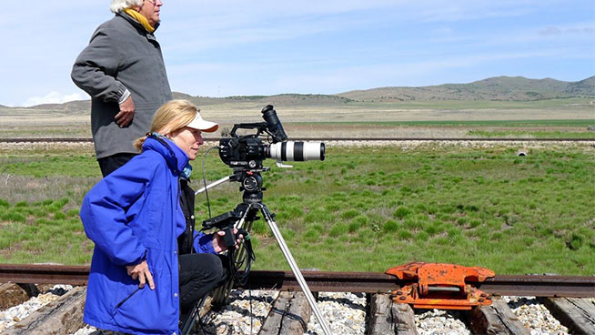 Maggie Stogner filming in a field