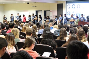 International students attending an orientation at an auditorium.