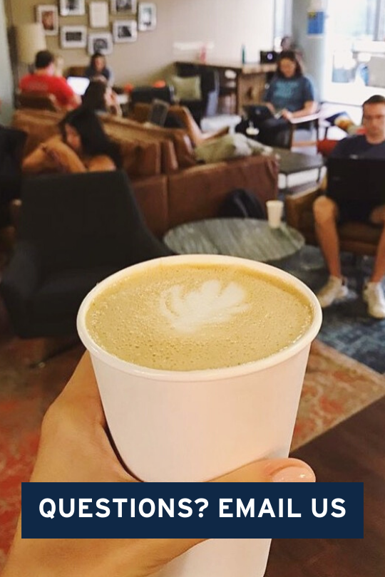 Hand holding up a latte in front of sitting area, with a blue square that says "Questions? Email Us."