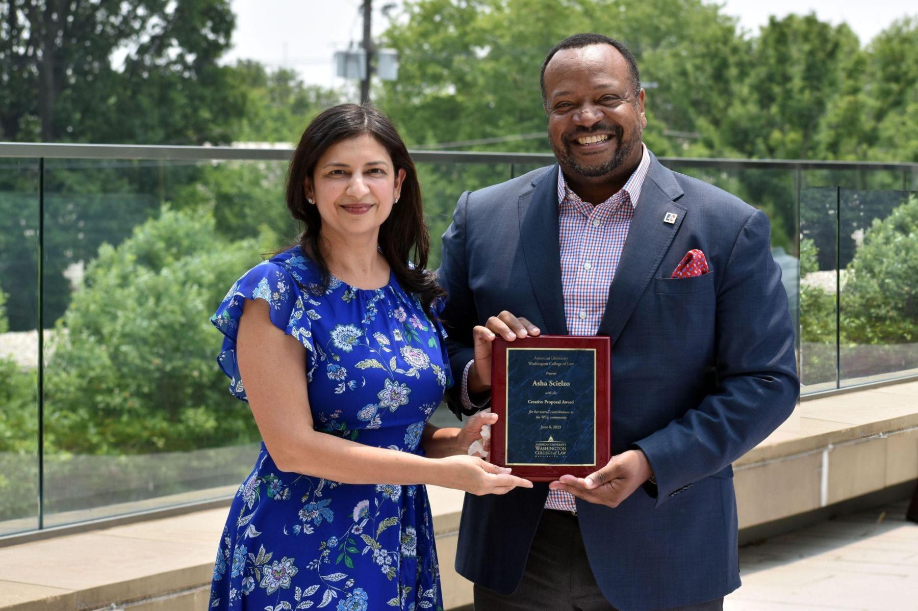 Asha Scielzo receiving the Creative Proposal Award from Dean Fairfax Asha Scielzo receiving the Creative Proposal Award from Dean Fairfax